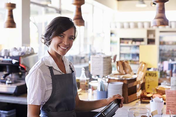 Female Employee Working At Delicatessen Checkout